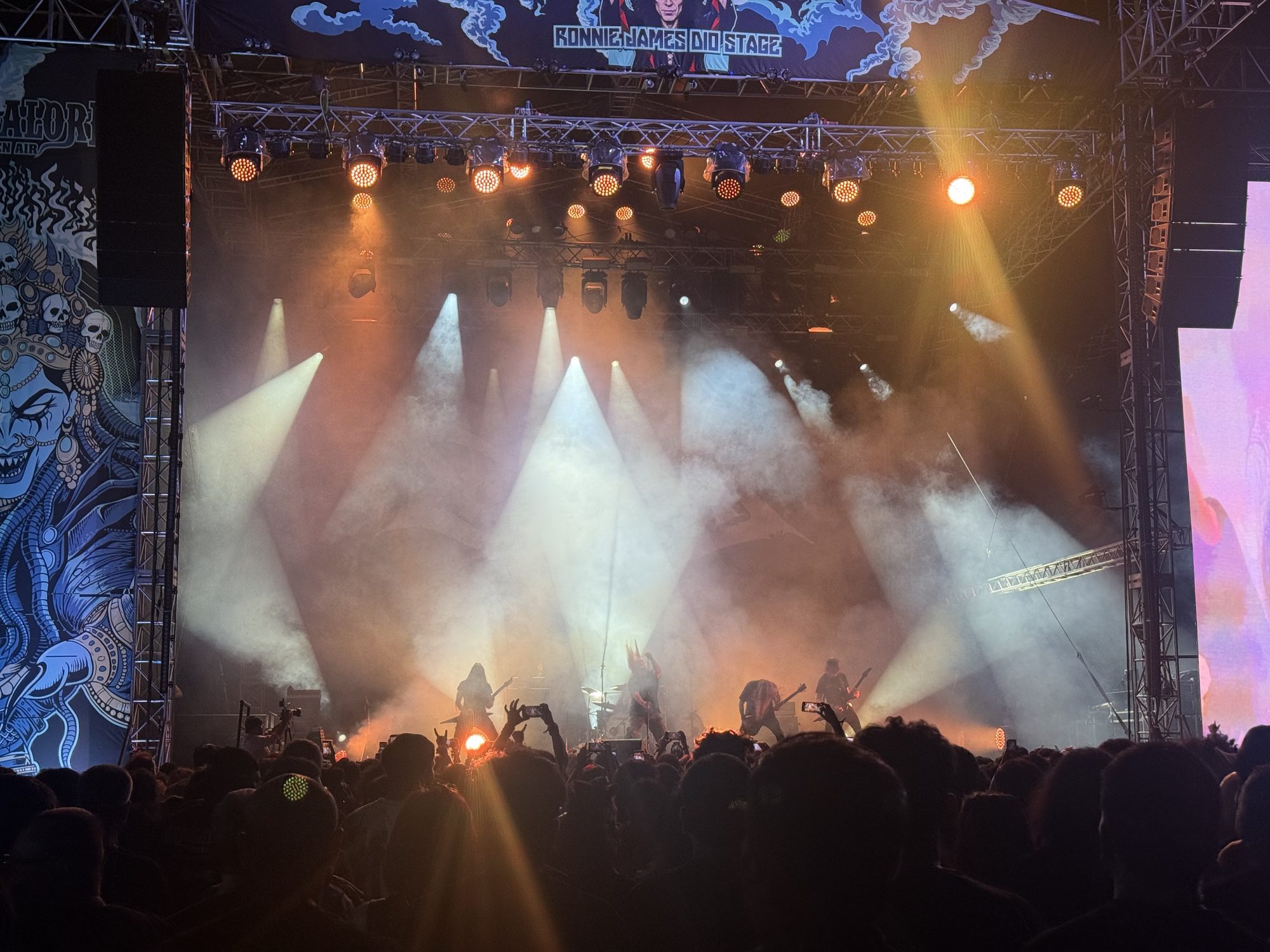 Wide shot of the stage lights and crowd as the night fell